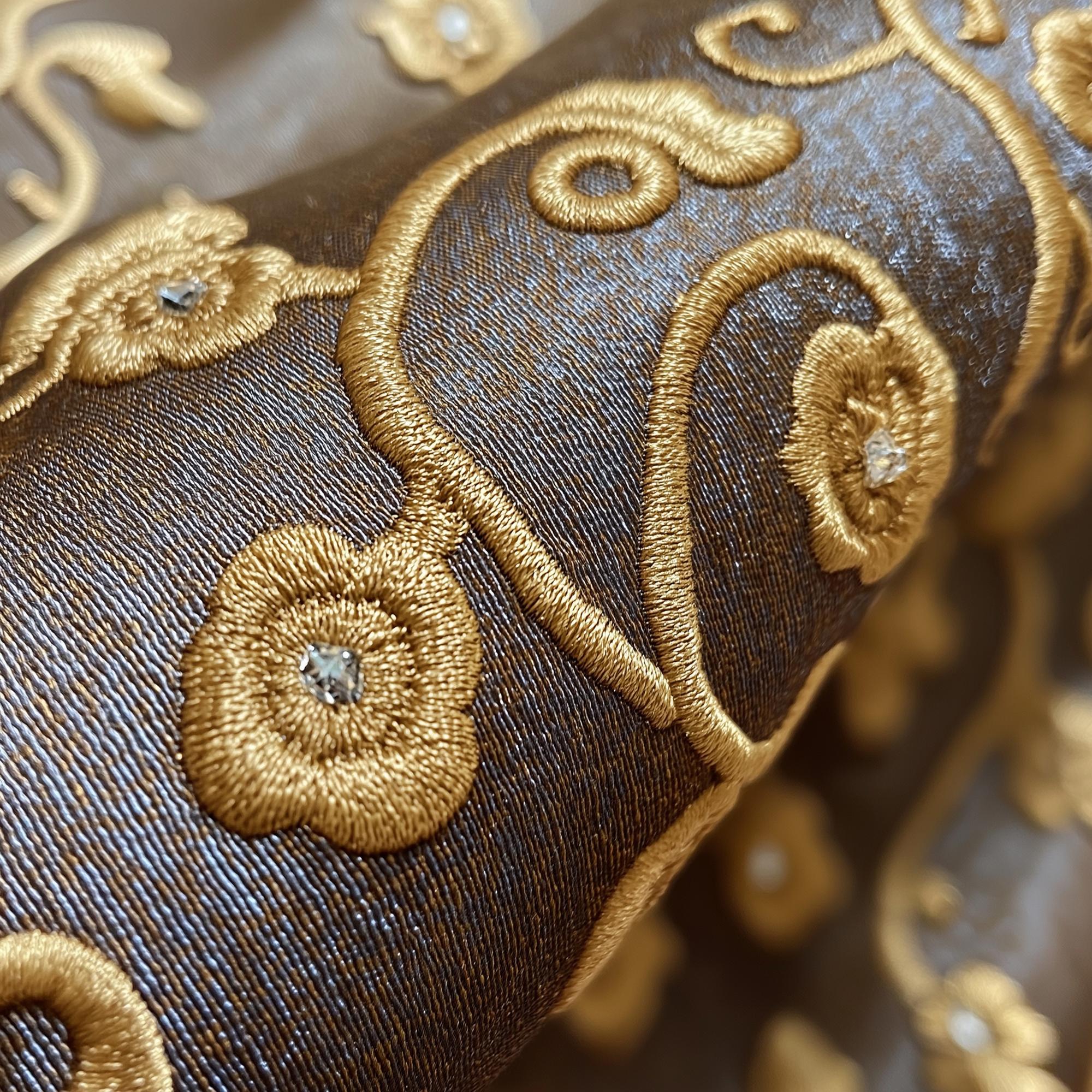 close-up luxury embroidered textile with gold thread